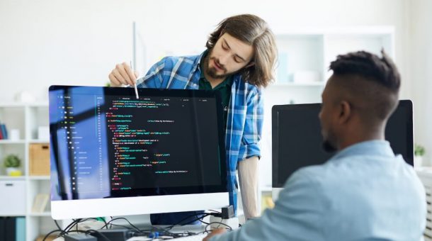 One man teaching another about code