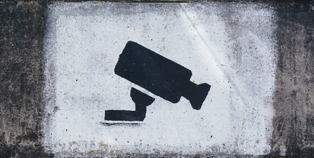 Graffiti of a security camera sprayed on a wall