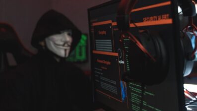 person in black hoodie using computer