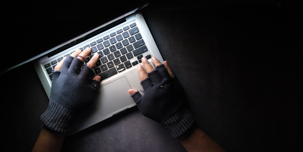 Hackers hands on laptop keyboard